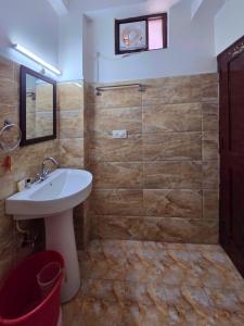 a bathroom with a sink and a glass shower at Hotel City Gold - Hotel in Dharamshala in Dharmsala +73 photos