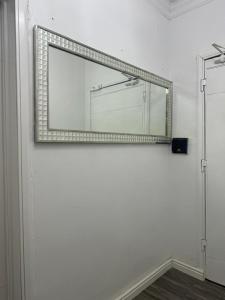 a mirror on a white wall in a room at SmartFix Luxury Properties in Lagos