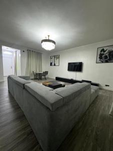a large couch in a living room with a television at SmartFix Luxury Properties in Lagos +8 photos