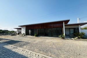 a building with a lot of windows and a driveway at Selline Bed and Breakfast in Bacnotan