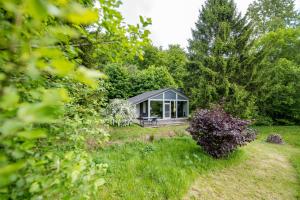 a tiny house in the middle of a garden at 4 Personen mit Sauna F2H8 in Ruhla +11 photos