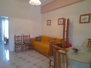 a living room with a bed and a table at Petalidi Square in Petalidi