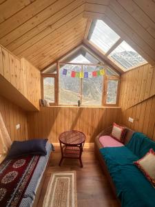 an attic room with two beds and a window at Shrenbute Cottage in Tāndi