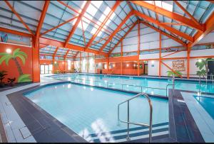 a large indoor swimming pool with a large indoor swimming pool at FI005 Loomy Escapes Caravan at St Osyth Beach Essex in Saint Osyth