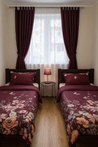 a bedroom with two beds and a window at TK Apartments Spiżowa in Wrocław