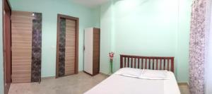 a bedroom with a bed in a room at Jee Inn Homestay in Guwahati