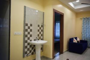 a bathroom with a sink and a shower at Jee Inn Homestay in Guwahati