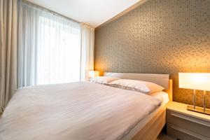 a bedroom with a white bed and a window at AH Fatranska VUSCH in Košice