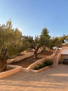a park with trees and stairs in a park at OLIVE&VIEW in Nea Moudania