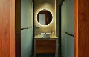 a bathroom with a sink and a mirror at Come to Xipuman B&B in Baishi
