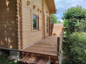 a wooden walkway to a tiny house at Le chalet des Sarteaux in Ville-sur-Lumes +15 photos