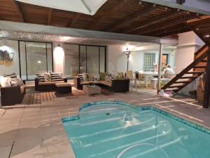 a swimming pool in the middle of a living room at Hermanus Cliff Path Lodge - No Load-shedding in Hermanus