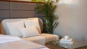 a living room with a couch and a glass table at Studio 205 Aibnb Mactan Cebu in Lapu Lapu City