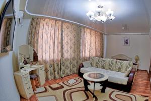 a living room with a couch and a table at Gostinitsa Tselinnaya in Kostanay