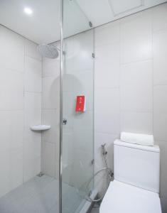a bathroom with a glass shower with a toilet at Red Planet Manila Bay in Manila