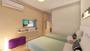 a room with a bed and a tv on a wall at Blue Palace Apart Hotel in Marmaris