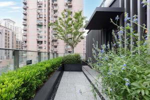 a garden on the side of a building with plants at Atour S Hotel Tianshan Road in Shanghai