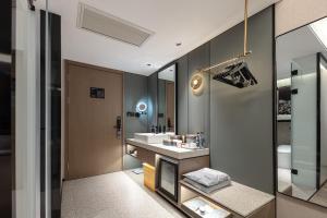 a bathroom with a sink and a mirror at Atour S Hotel Tianshan Road in Shanghai +45 photos