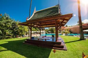 a pavilion with a roof next to a swimming pool at Hotel Botanico y Oriental Spa Garden in Puerto de la Cruz