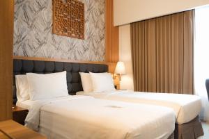 Postel nebo postele na pokoji v ubytování Crystalkuta Hotel - Bali