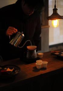 a man is using a tea kettle on a counter at Come to Xipuman B&B in Baishi +43 photos