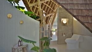 a bathroom with a toilet in a building at Mandala Eco Resort Lombok in Selong Belanak