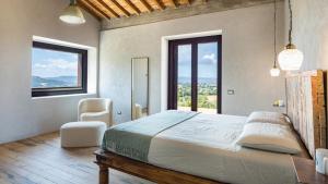 a bedroom with a large bed and large windows at CASALE THE PLACE 6&2, Emma Villas in Petroro +37 photos