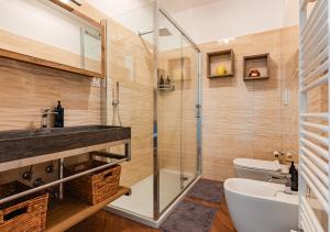 a bathroom with a shower and a sink and a toilet at Villa Elegance - With Garden and Private Gym in Livorno +44 photos