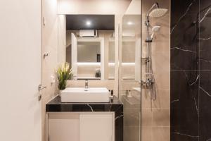 a bathroom with a sink and a shower at WYZ Museum by UPSTREET in Athens +41 photos