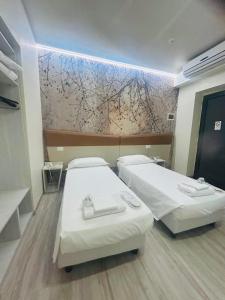 A bed or beds in a room at Hotel Giardinetto Al Sant'Orsola
