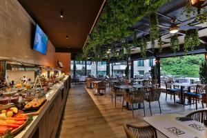 a restaurant with a buffet line with tables and chairs at Regent Resort Budva in Budva