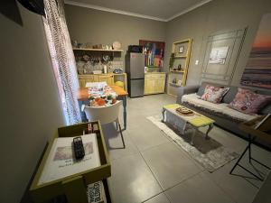 a living room with a couch and a table at Cottage on Kort Deluxe in Parys