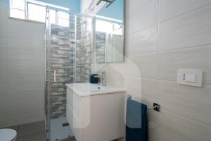 a bathroom with a sink and a shower at Homiday - Appartamento Rosy in Pineto