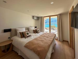Katil atau katil-katil dalam bilik di Appartement à 100mètres du lac avec terrasse privée - Vue panoramique sur le lac