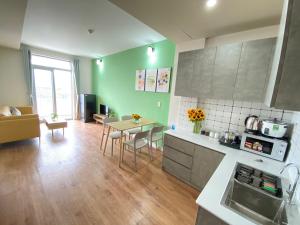 a kitchen and living room with a table and chairs at Colline' House In Phan Rang in Kinh Dinh
