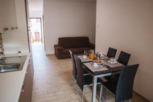 a dining room with a table with chairs and a couch at Villa Giusi in Tropea