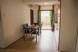 a dining room with a table and chairs and an open door at Villa Giusi in Tropea +22 photos