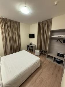 A bed or beds in a room at Hotel Giardinetto Al Sant'Orsola