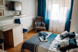 a bedroom with a bed with a tray of food on it at Apartamenty Camila in Rewa