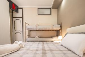 a bedroom with three bunk beds in a room at Family Nest - Tra il Mare, il Centro e il Relax in Misano Adriatico