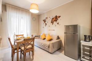 a living room with a couch and a table and a refrigerator at Family Nest - Tra il Mare, il Centro e il Relax in Misano Adriatico +13 photos