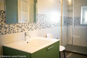 a bathroom with a sink and a shower at 8 Archi sul Mare Exclusive Ferris Wheel View in Bari +67 photos