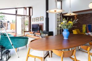 a living room with a table with a vase of flowers on it at Casa de Neiva in Esposende