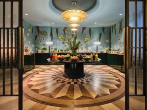 a lobby with a table with fruit on it at Rocco Forte The Charles Hotel in Munich