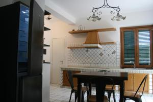 a kitchen with a table and chairs in a room at Sottocoperta Palinuro in Palinuro