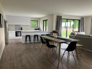 a kitchen and living room with a table and chairs at 3-Bedroom Retreat in Mount Somers in Mount Somers