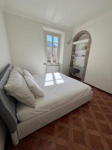 a bedroom with a large bed and a window at IlNanoaComo, HolidayApartment in the Heart of Como in Como