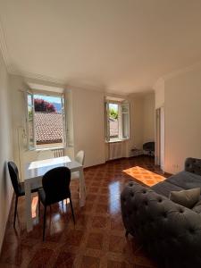 a living room with a couch and a table at IlNanoaComo, HolidayApartment in the Heart of Como in Como +11 photos