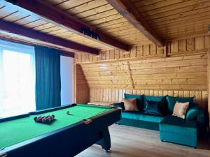 una camera con tavolo da biliardo e divano di Willa Widokowa - sauna, balia, basen, biliard a Międzybrodzie Bialskie