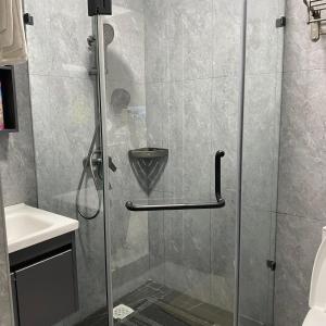 a shower with a glass door in a bathroom at Lovely one bedroom in Kilimani near yaya centre in Nairobi